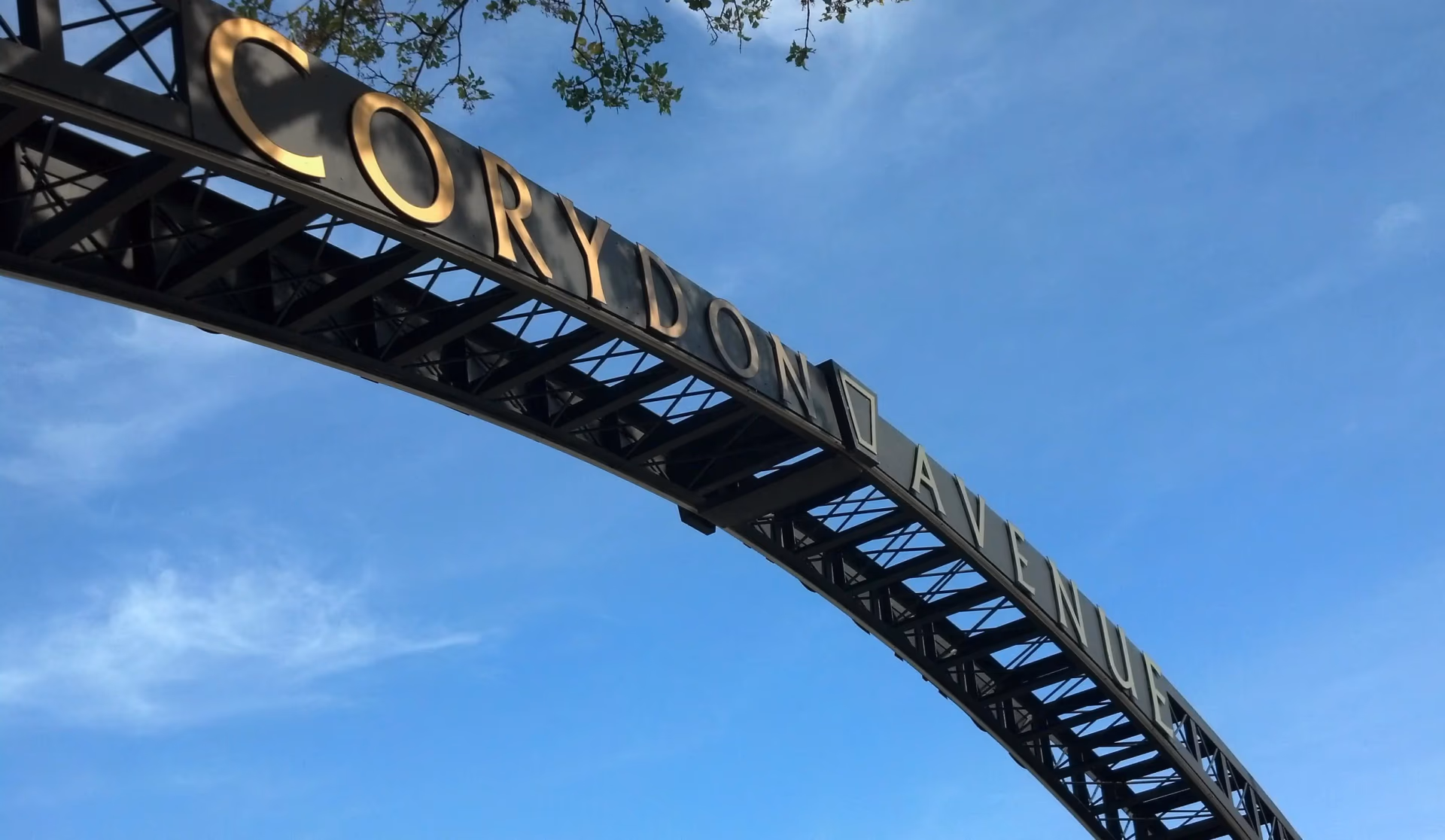The Corydon Avenue gateway arch against a Winnipeg sky