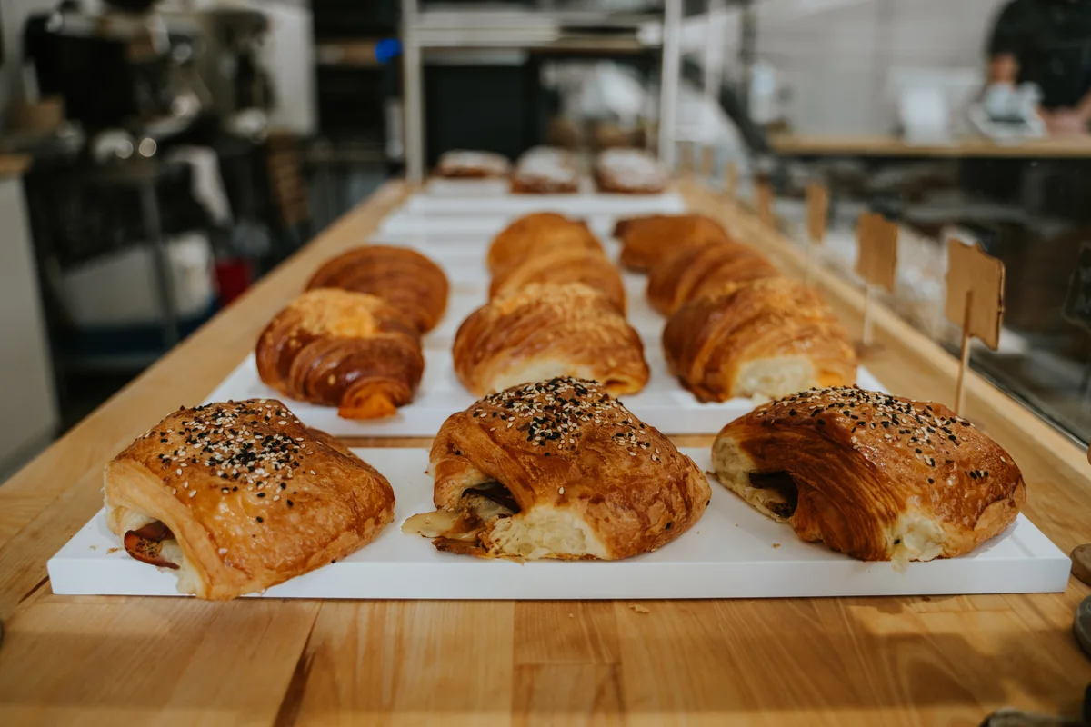 Fresh pastries arranged on a wooden bakery counter